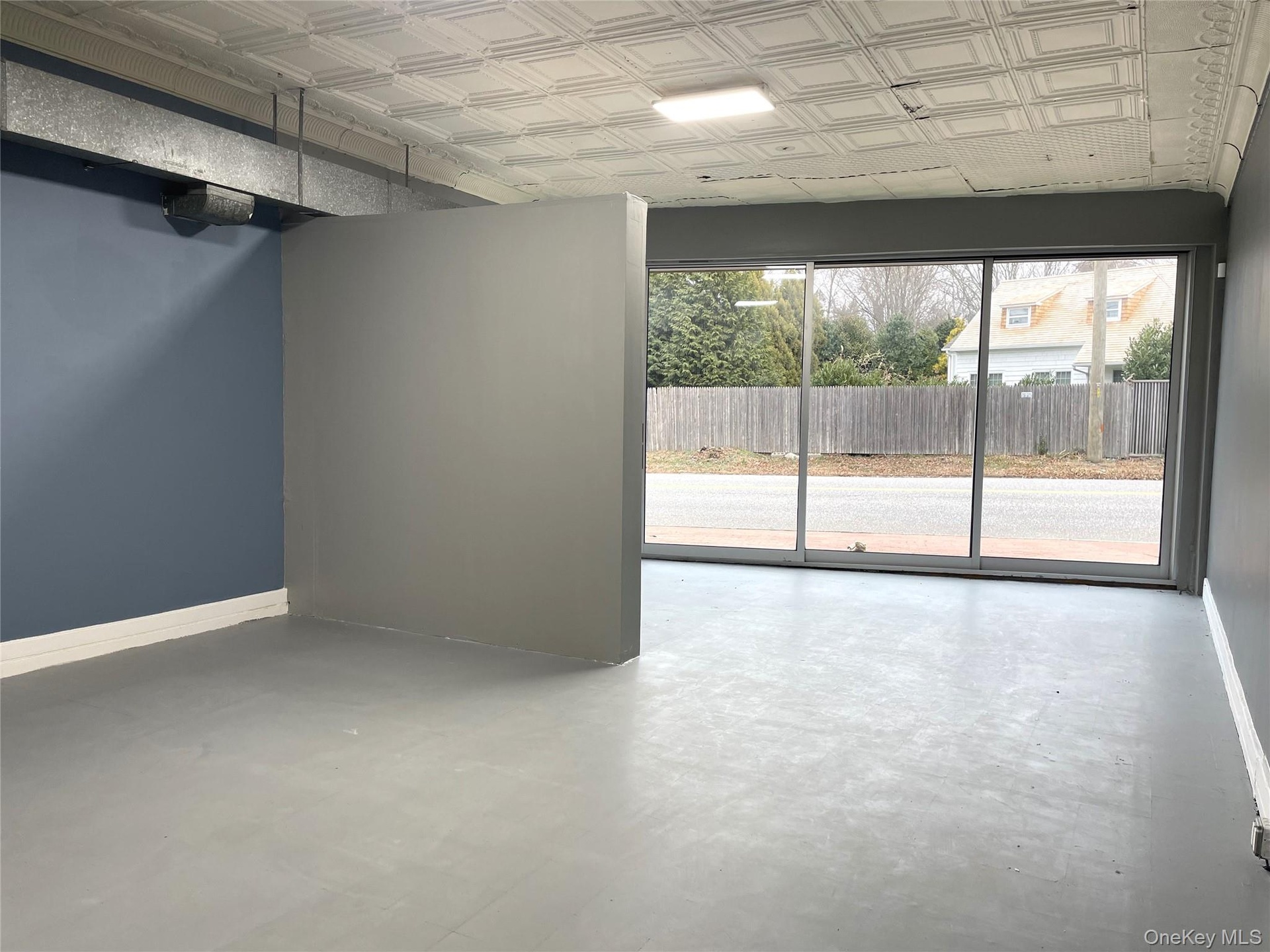 Spare room featuring an ornate ceiling and finished concrete floors