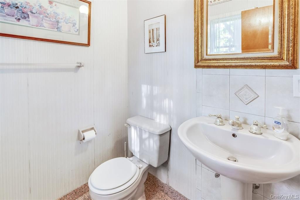 Half bathroom featuring toilet and baseboards