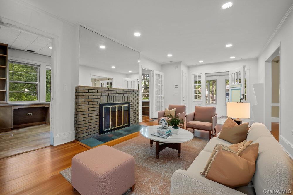 Living area featuring wood finished floors, a fireplace, and recessed lighting