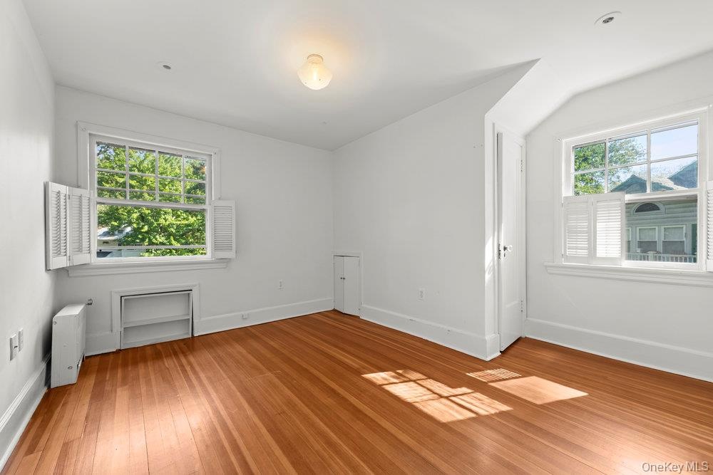 Unfurnished room with baseboards and light wood-style floors