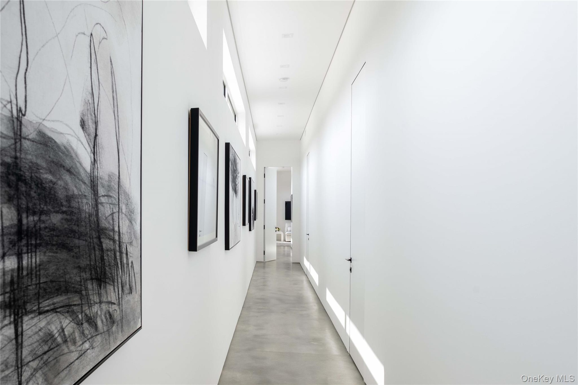 Hallway featuring concrete flooring