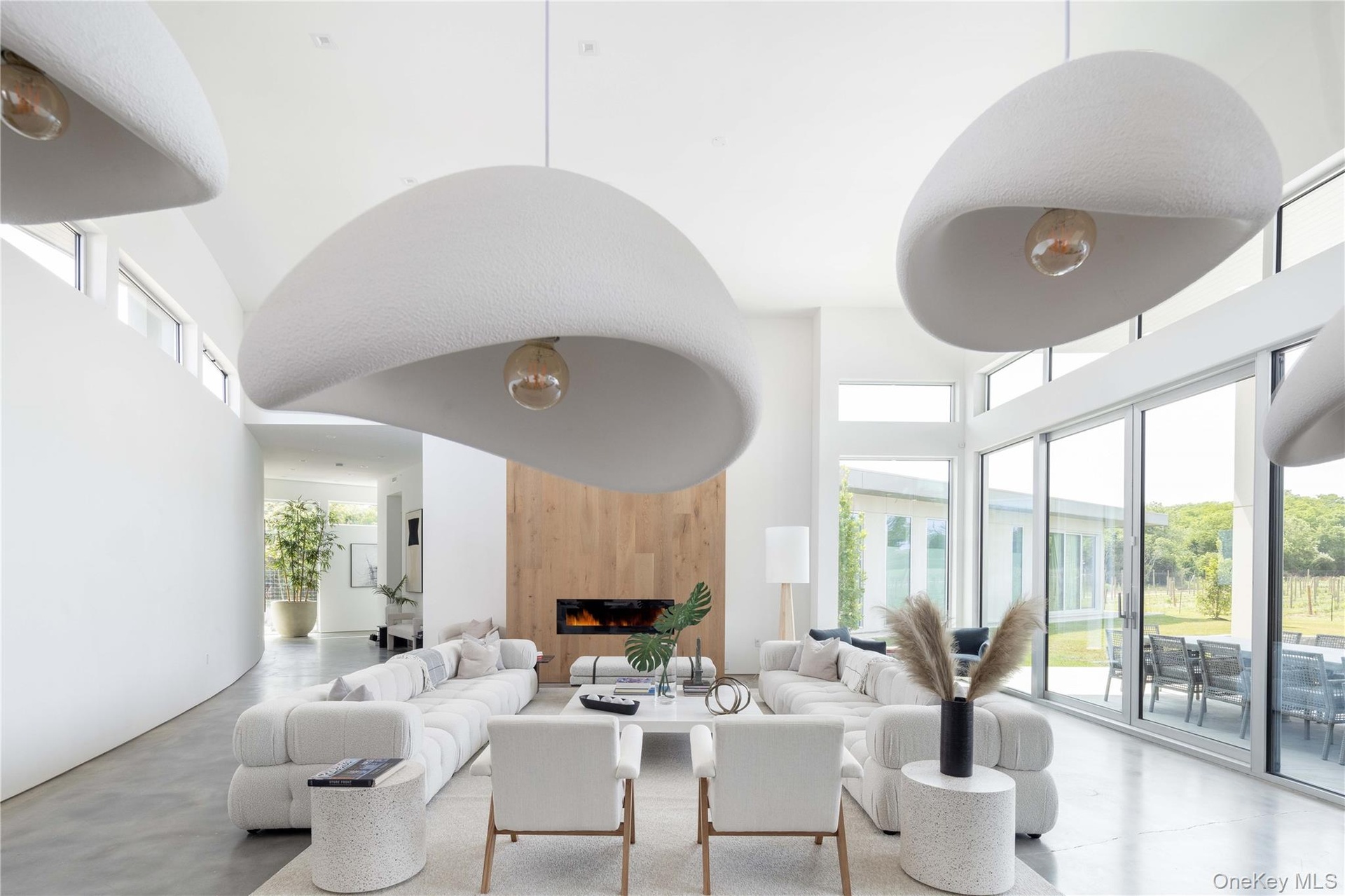 Living room with a fireplace and a high ceiling