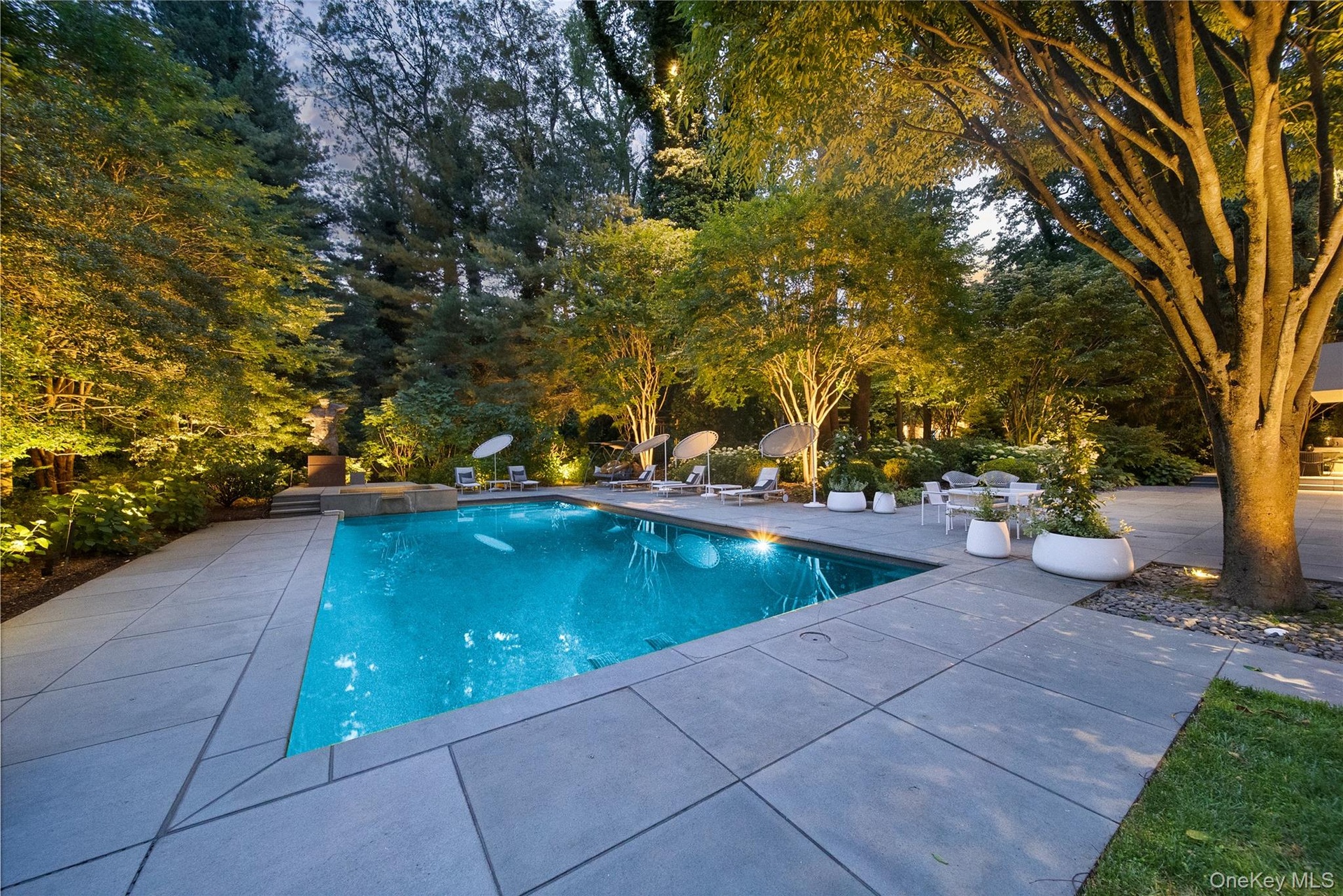 View of pool featuring a patio and a pool with connected hot tub