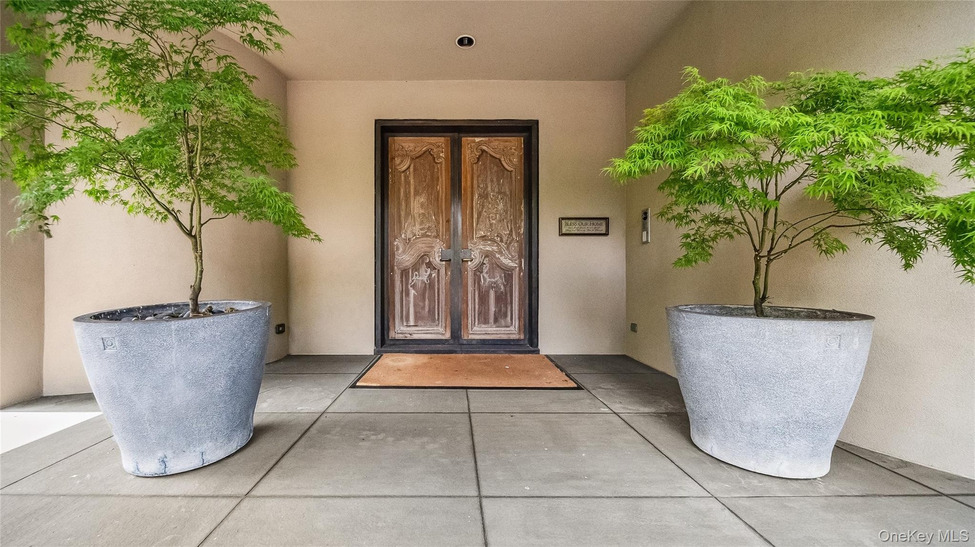 Entrance To The Interior Featuring Custom French Chateau Doors Set In Custom Bronze Metal Surround