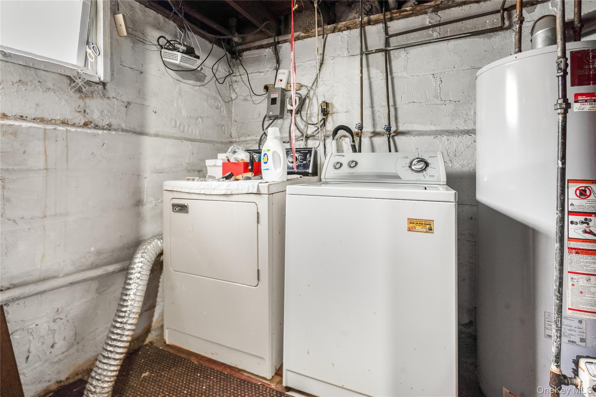Laundry area with gas water heater and washer and dryer