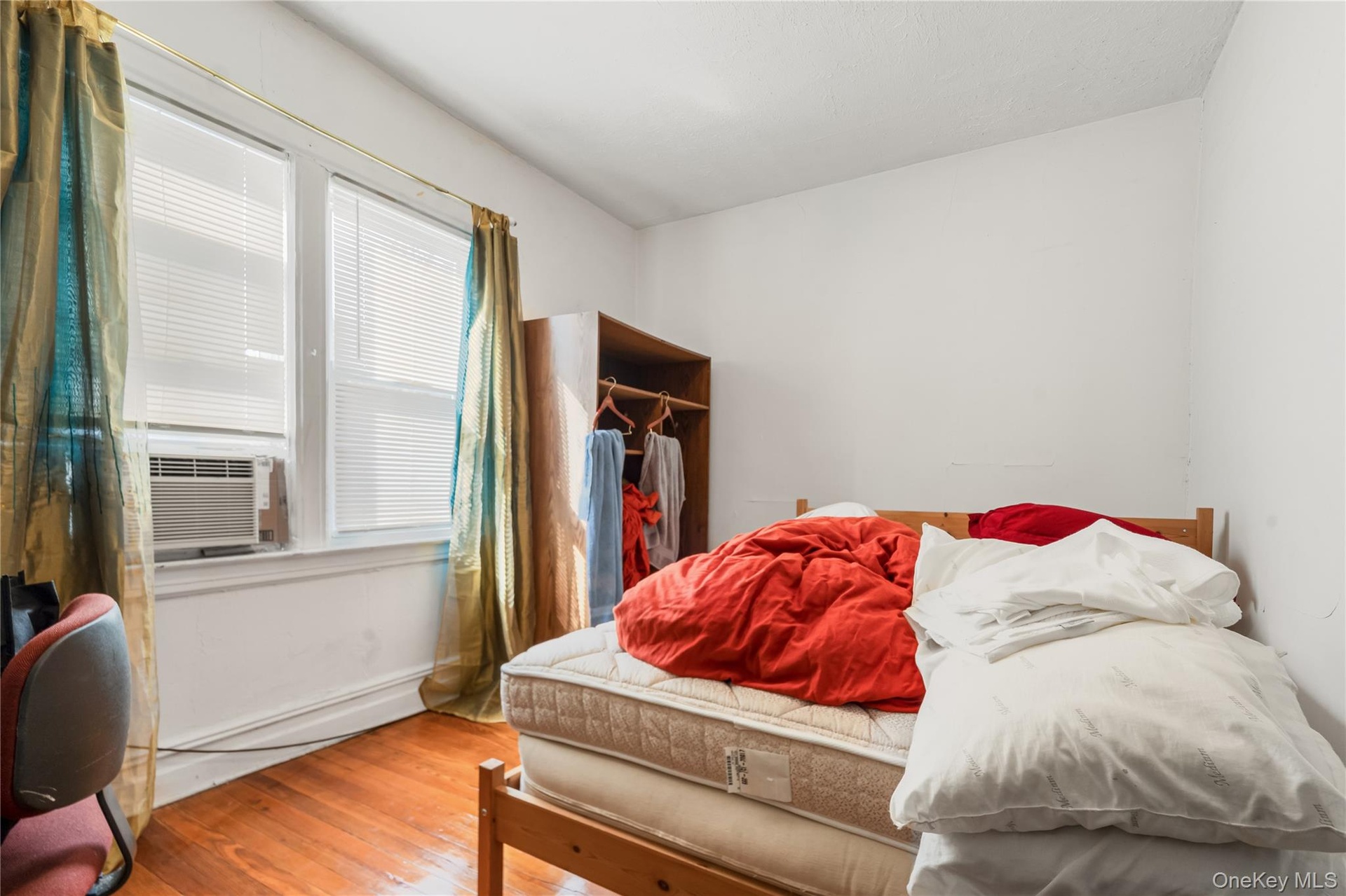 Bedroom featuring wood-type flooring and cooling unit