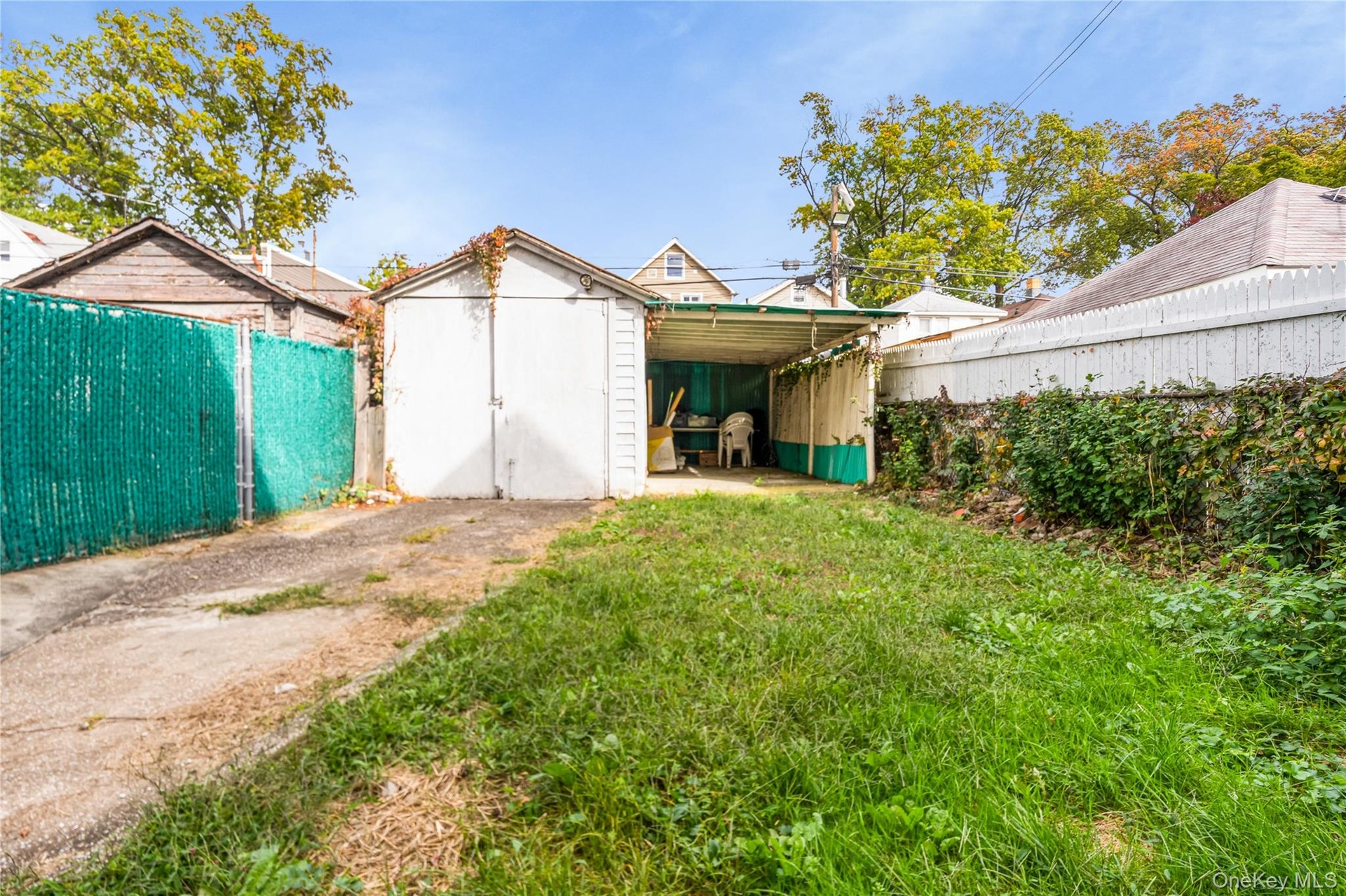Fenced backyard with a patio area and a storage shed