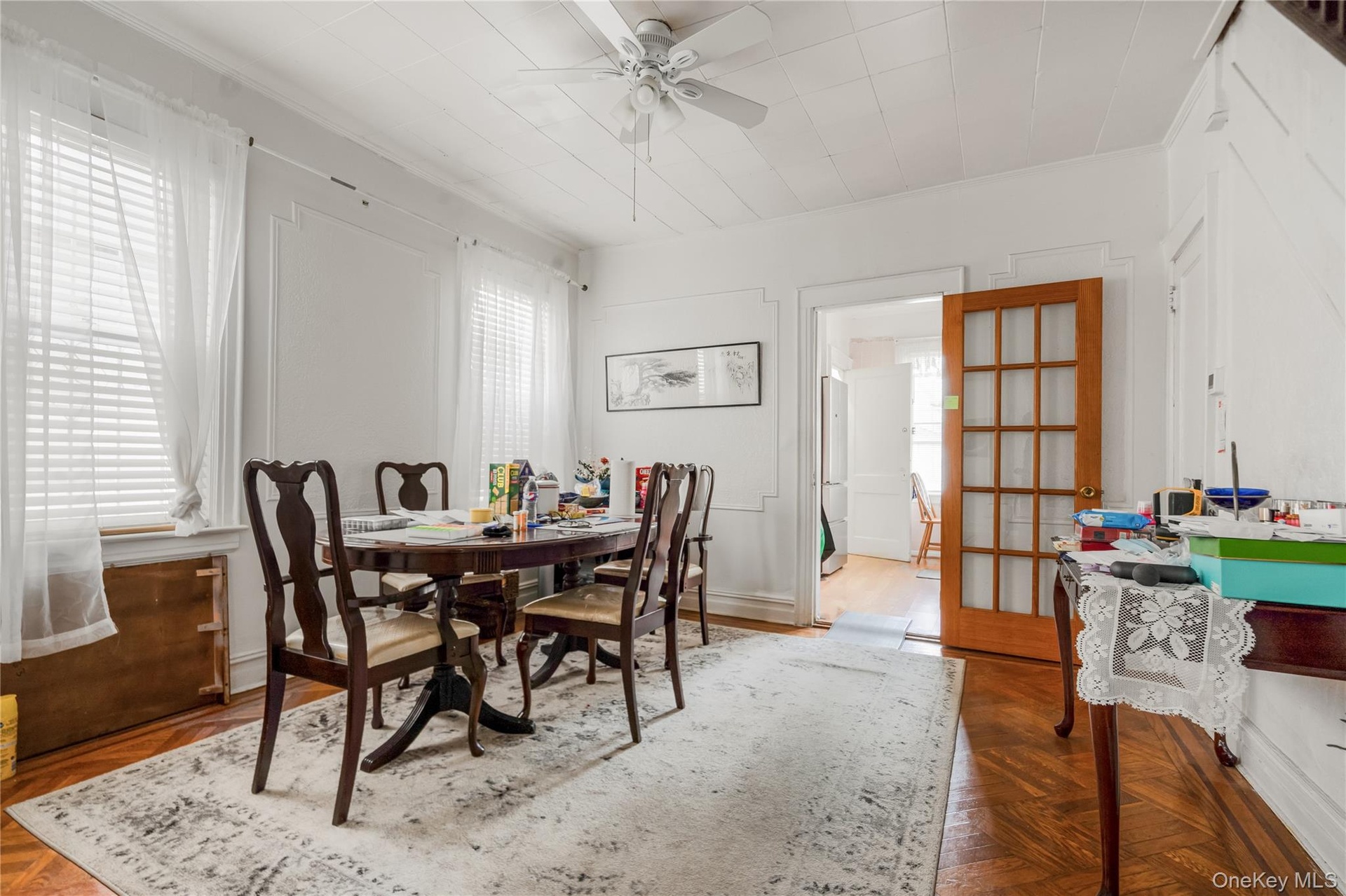 Dining space featuring ceiling fan and crown molding