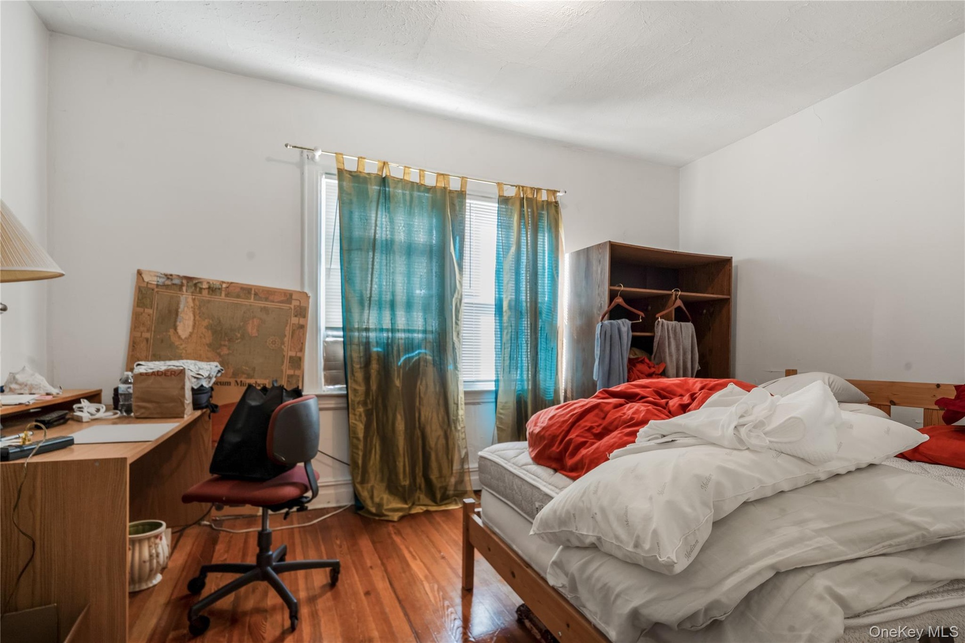 Bedroom with wood-type flooring and a desk