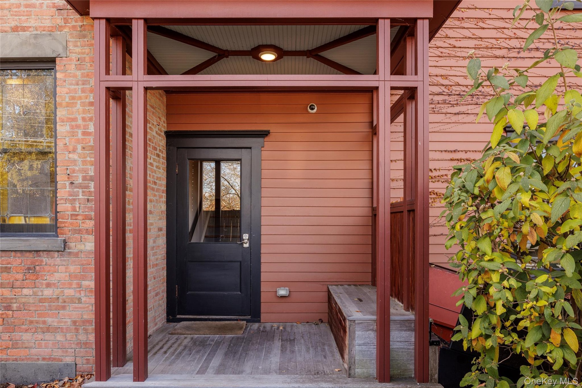 Doorway to property featuring brick siding