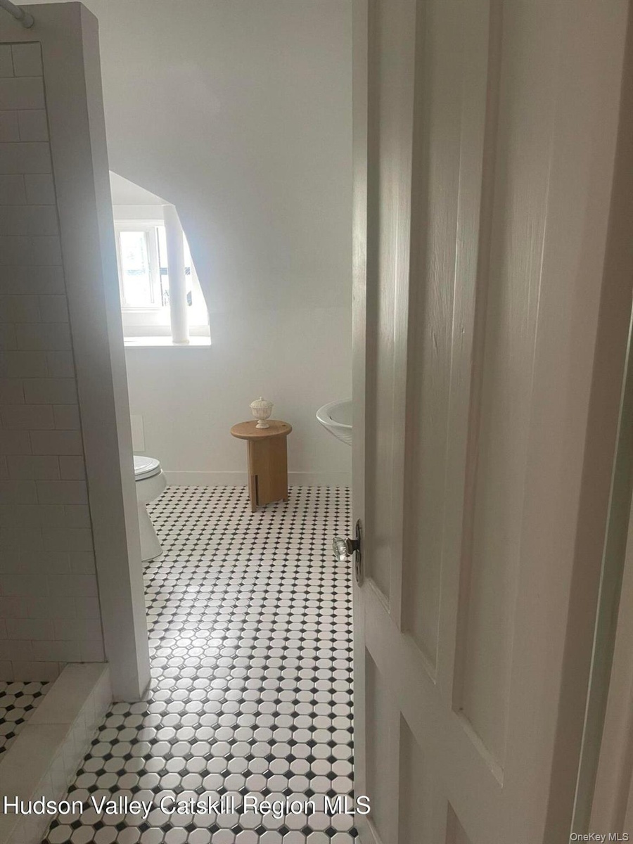 Bathroom with toilet and tiled shower