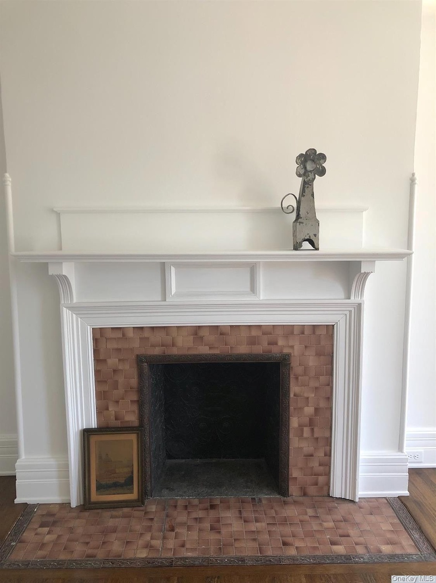 Detailed view of a fireplace and wood finished floors