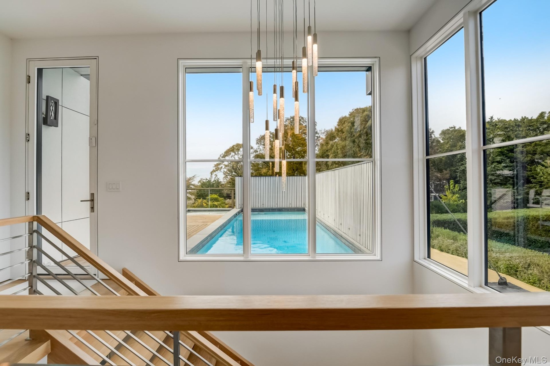 View of swimming pool with a chandelier