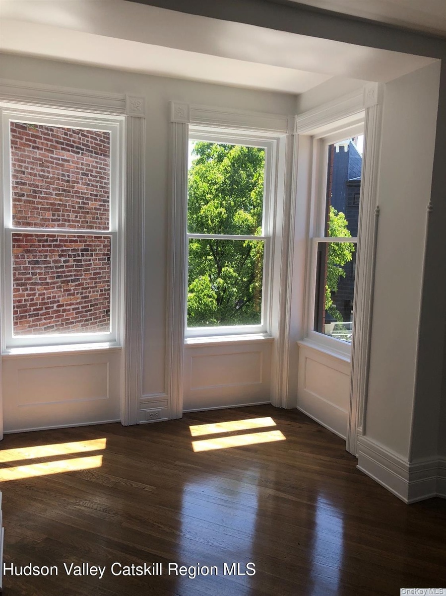 Entryway with wood finished floors and healthy amount of natural light