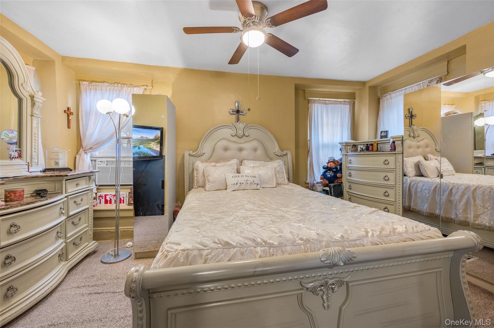 Bedroom with light carpet and ceiling fan