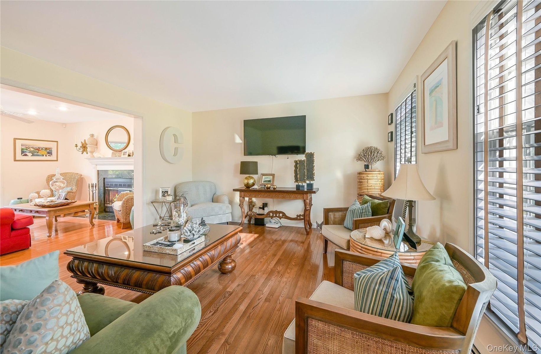 Living area featuring wood finished floors and a premium fireplace