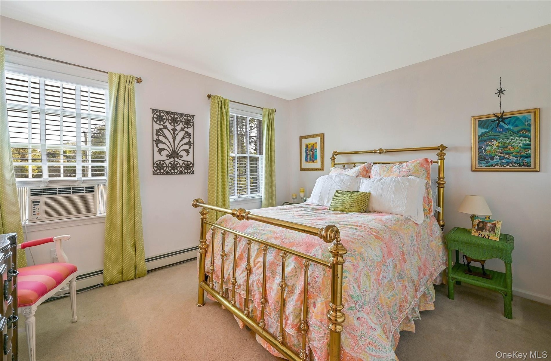 Bedroom featuring baseboard heating, cooling unit, and carpet flooring