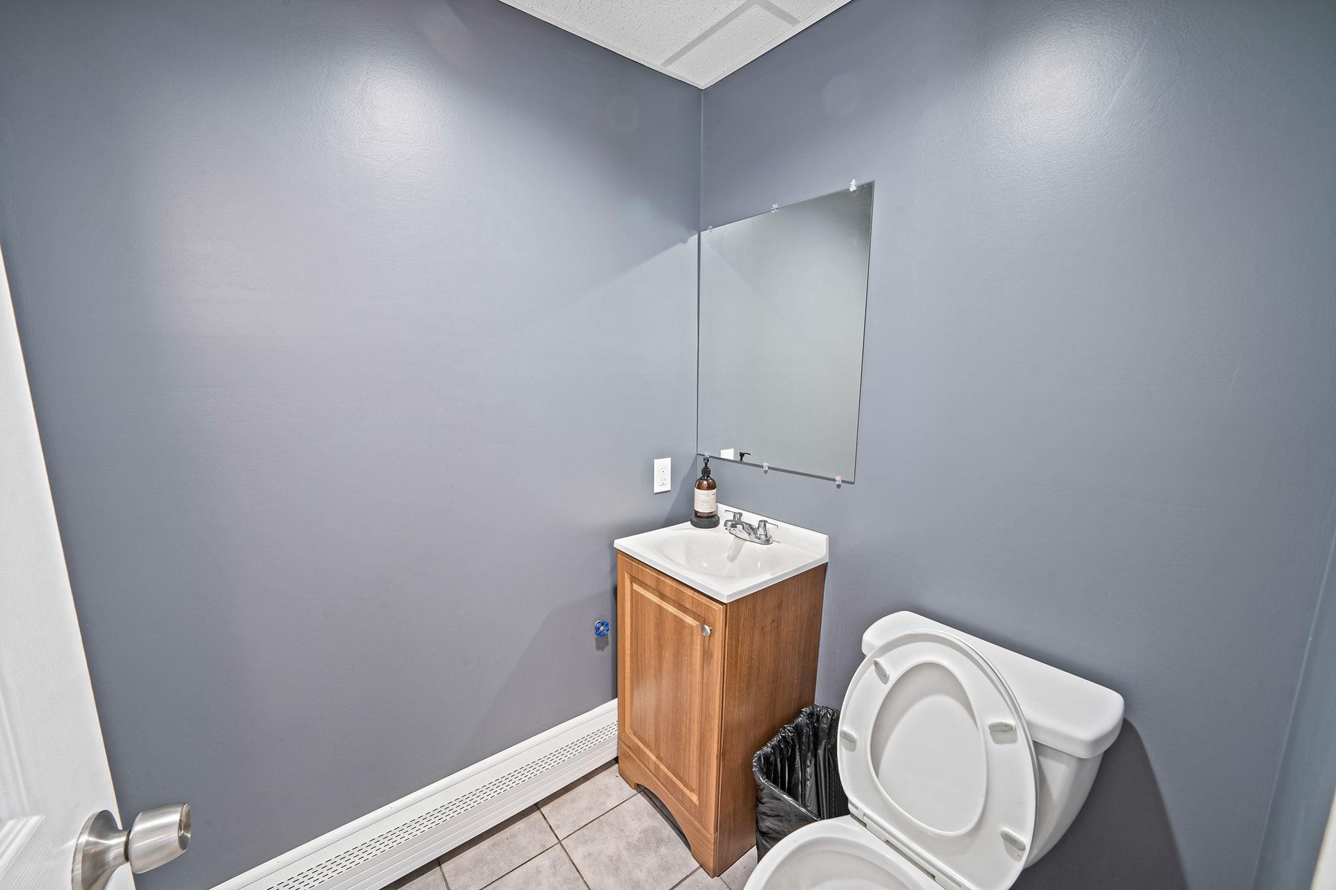 Half bath featuring tile patterned floors and vanity