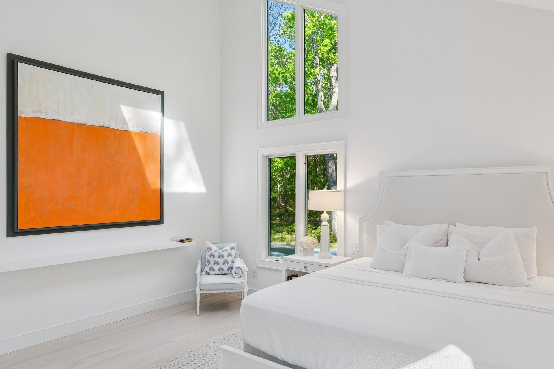 Bedroom with multiple windows, wood finished floors, and baseboards