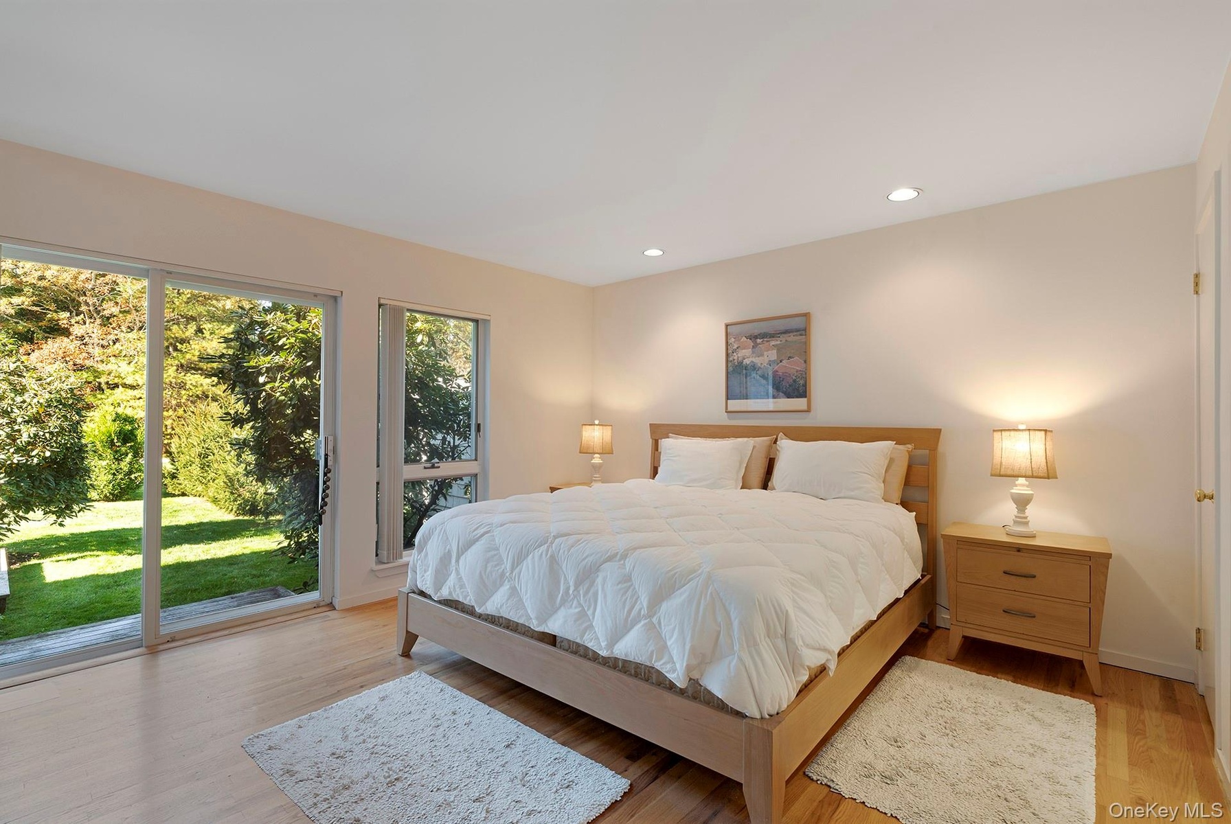Bedroom with access to exterior, light wood-style flooring, and recessed lighting