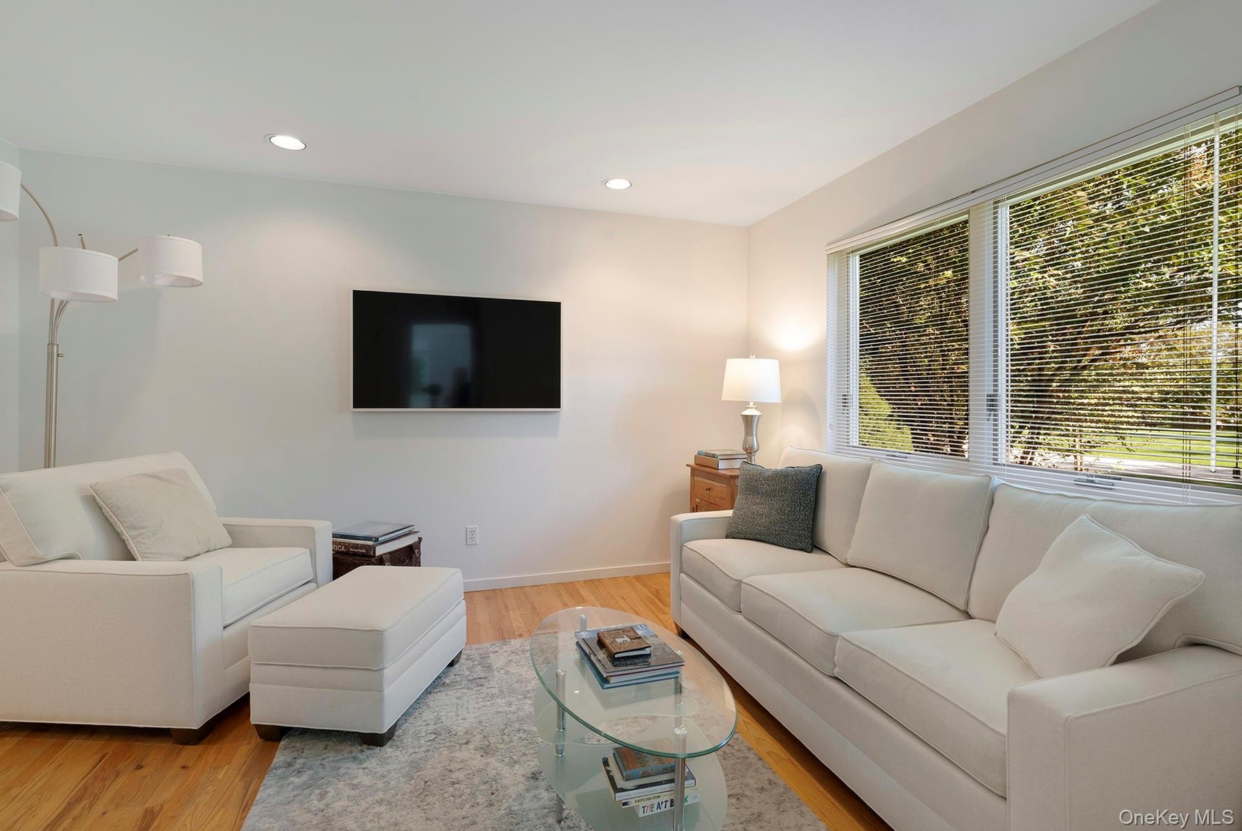 Living room with recessed lighting and light wood finished floors