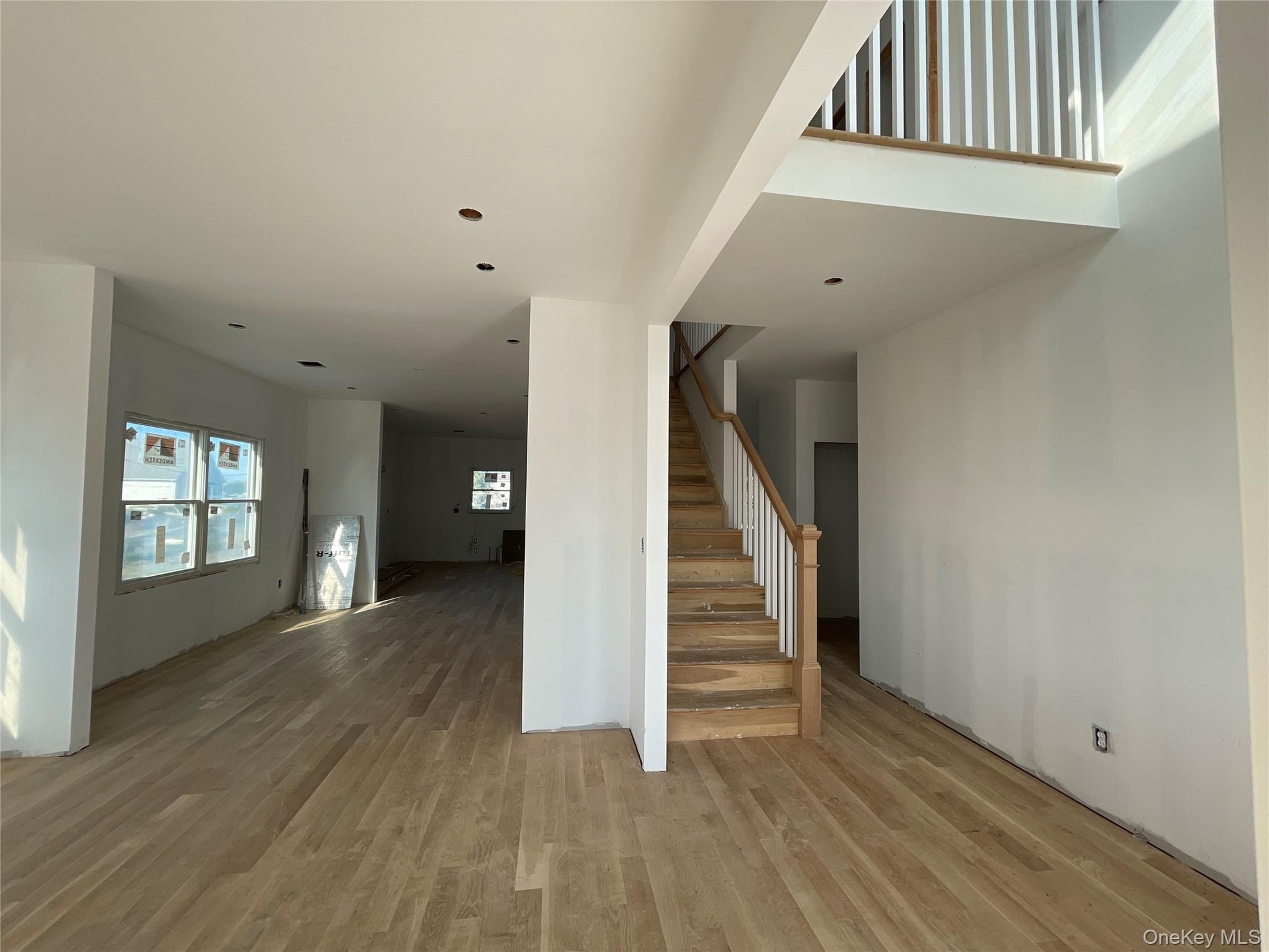 Stairs featuring wood finished floors