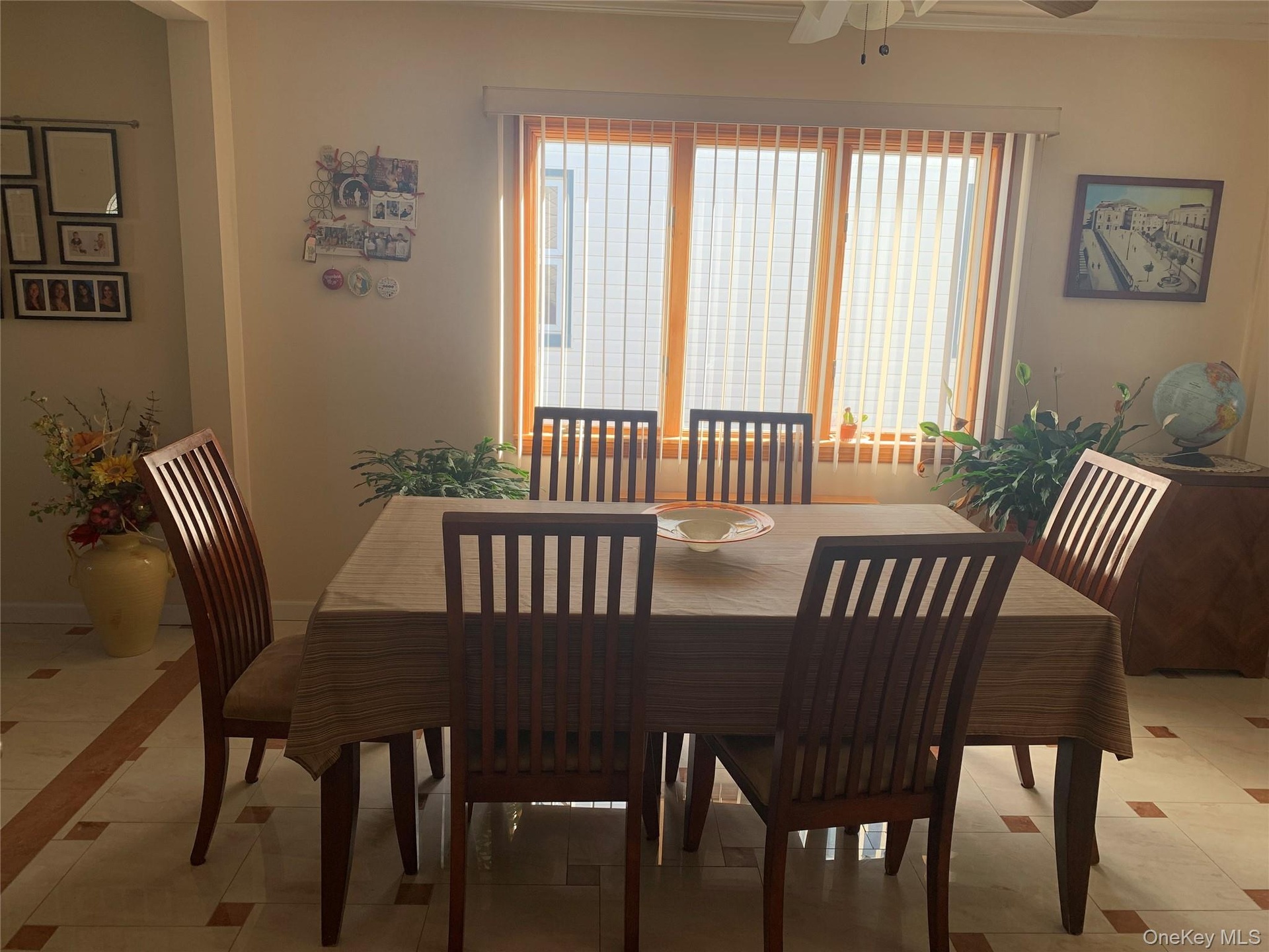 Dining space featuring light tile patterned floors, ornamental molding, and ceiling fan