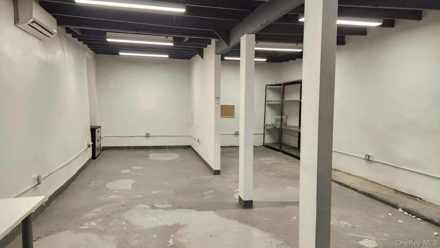Finished below grade area featuring a wall mounted AC