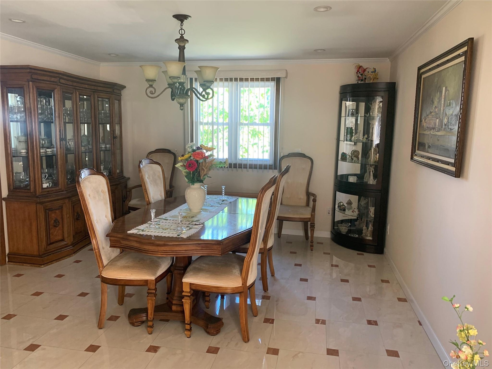 Dining room featuring crown molding and a chandelier