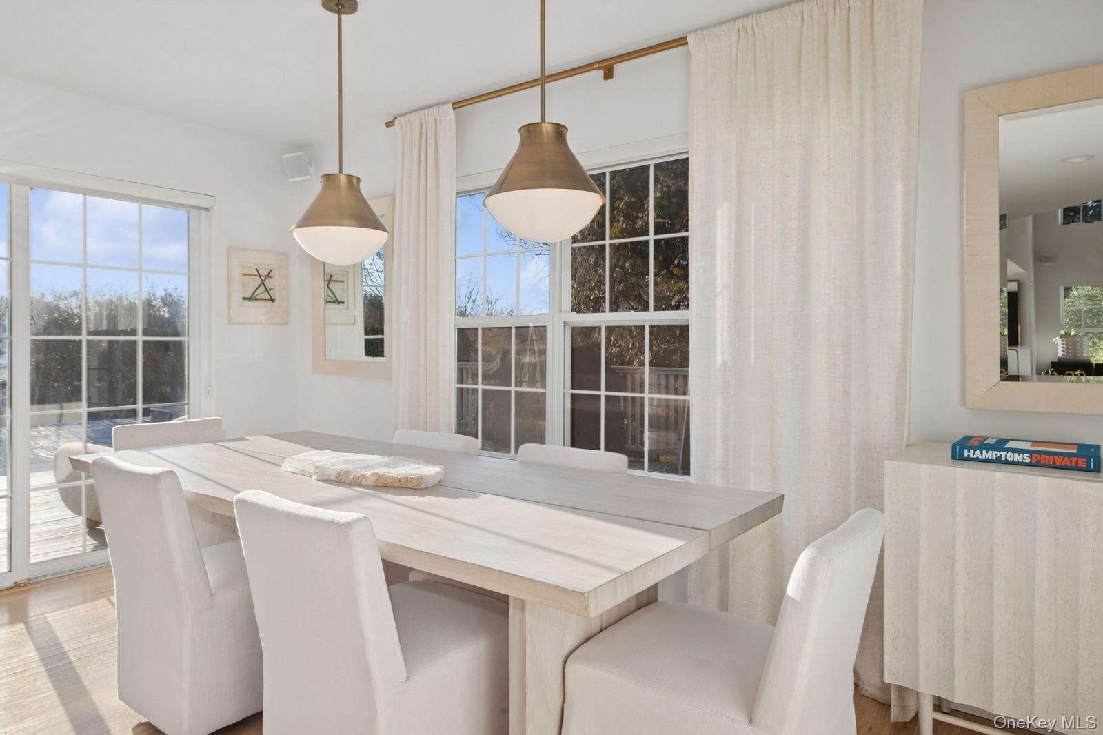 Dining space with healthy amount of natural light and light wood finished floors