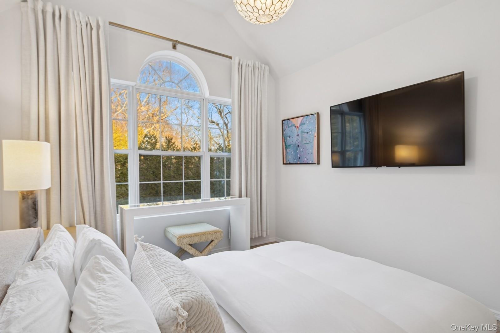 Bedroom with lofted ceiling