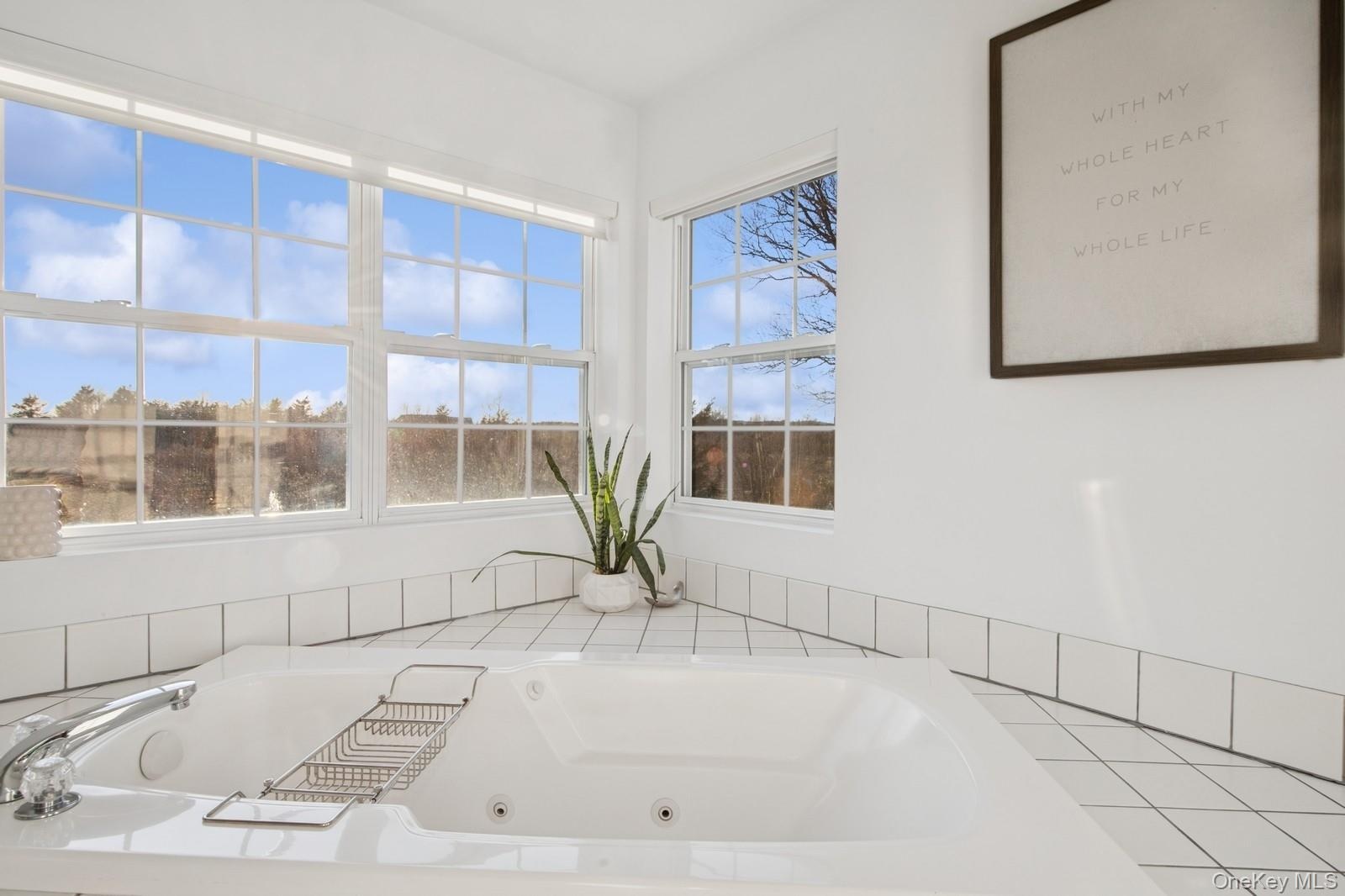 Full bathroom with a whirlpool tub