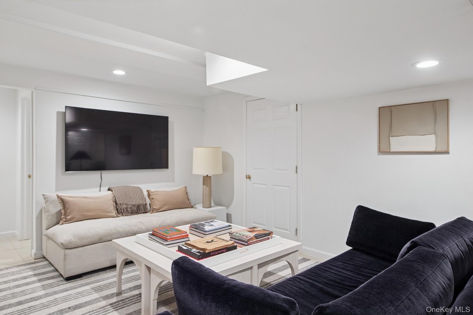 Living area featuring recessed lighting and baseboards
