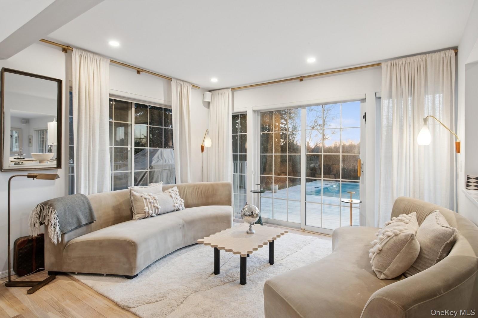Living room with wood finished floors and recessed lighting