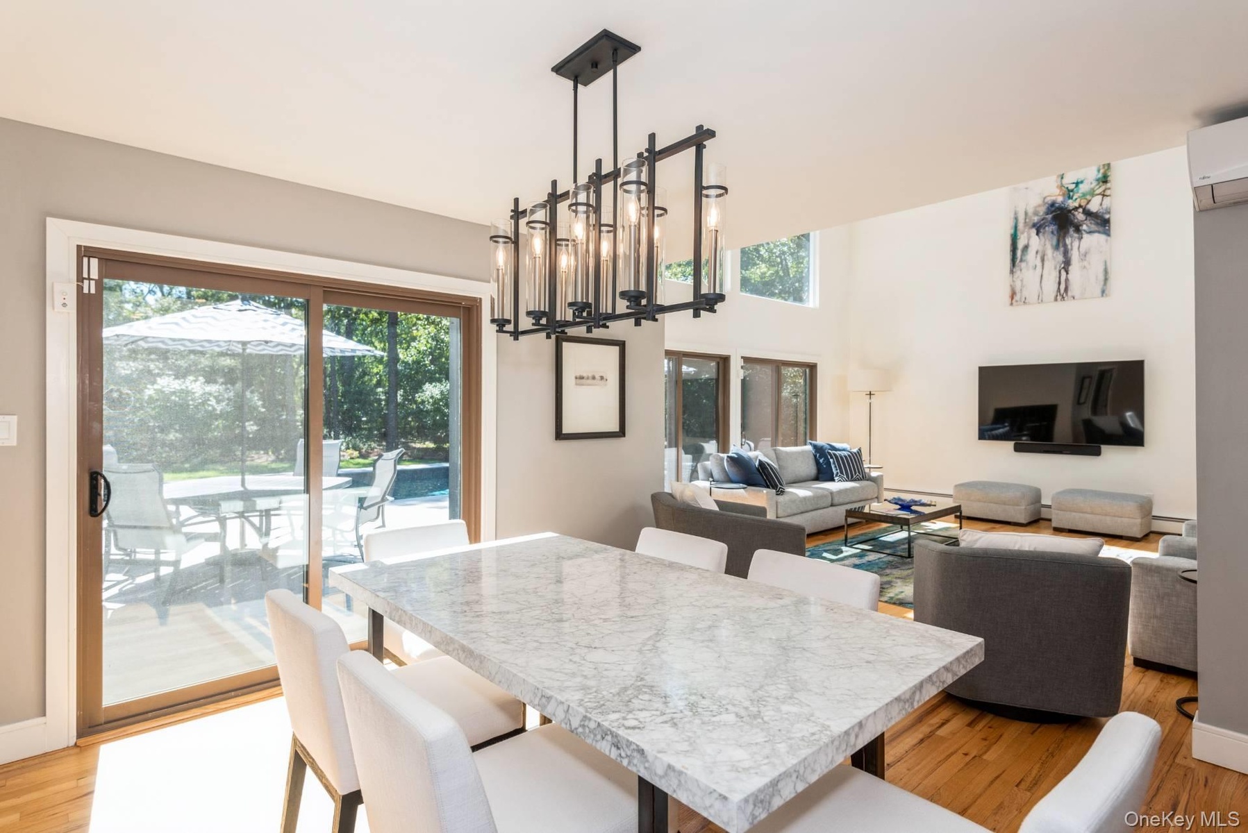 Dining area featuring light wood-type flooring and a wall unit AC