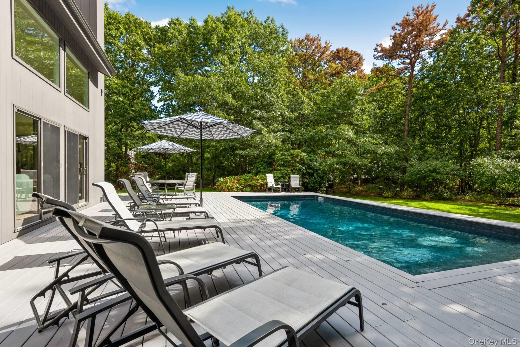 Swimming pool featuring a deck and outdoor dining space