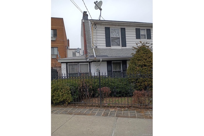 View of front facade featuring a fenced front yard and a chimney