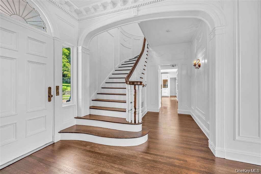The Staircase located off to the side of the Center Hall to Allow the Clear Through-View from Front to Back