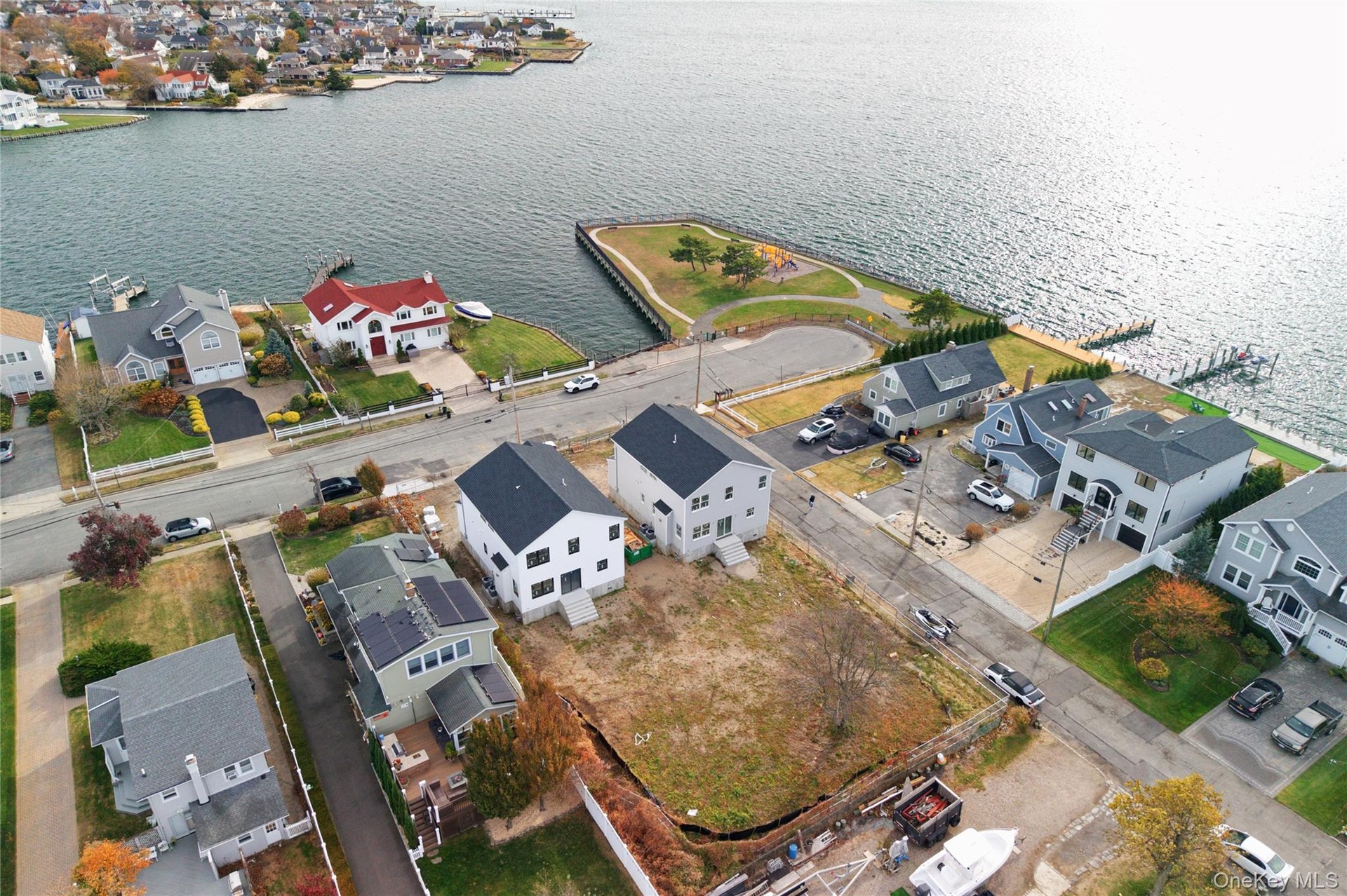 Aerial view of residential area featuring a nearby body of water