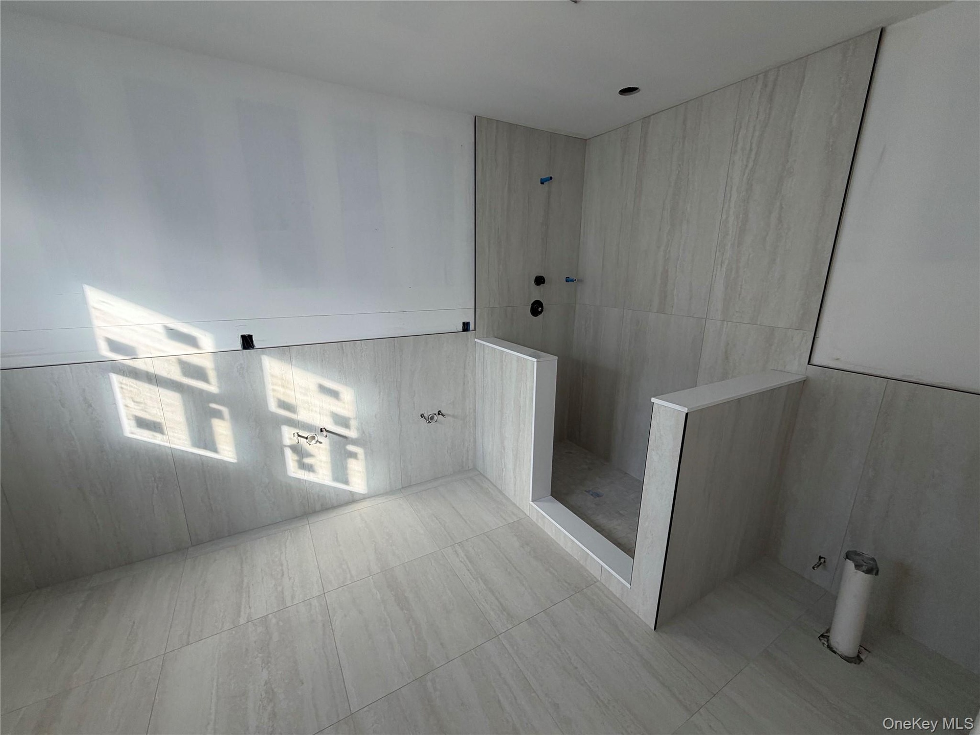 Full bath featuring walk in shower and tile patterned flooring