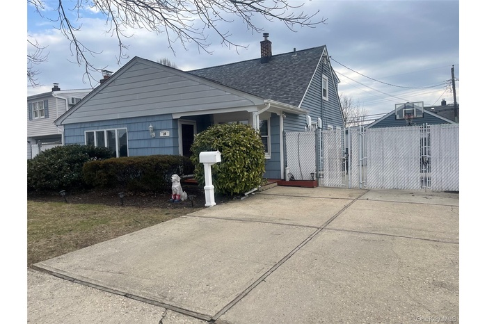 Exterior of home and large  driveway