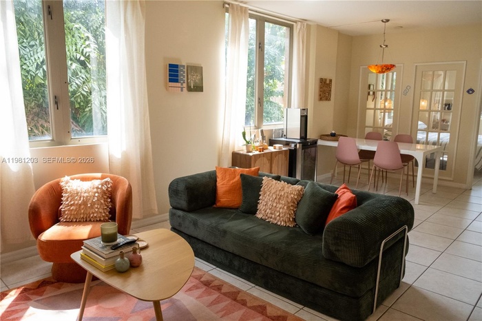 Charming tree top views and natural light enhance this corner unit condo. Bright open floor plan with ensuite bedroom, walk-in closet, inside laundry 