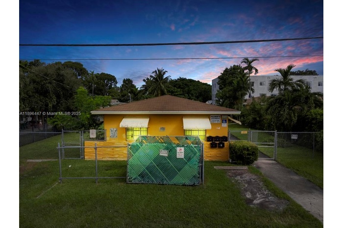 Beautiful twilight view of a Miami fourplex located in Little River, showcasing solid CBS construction and spacious front yard. Perfect income-produci