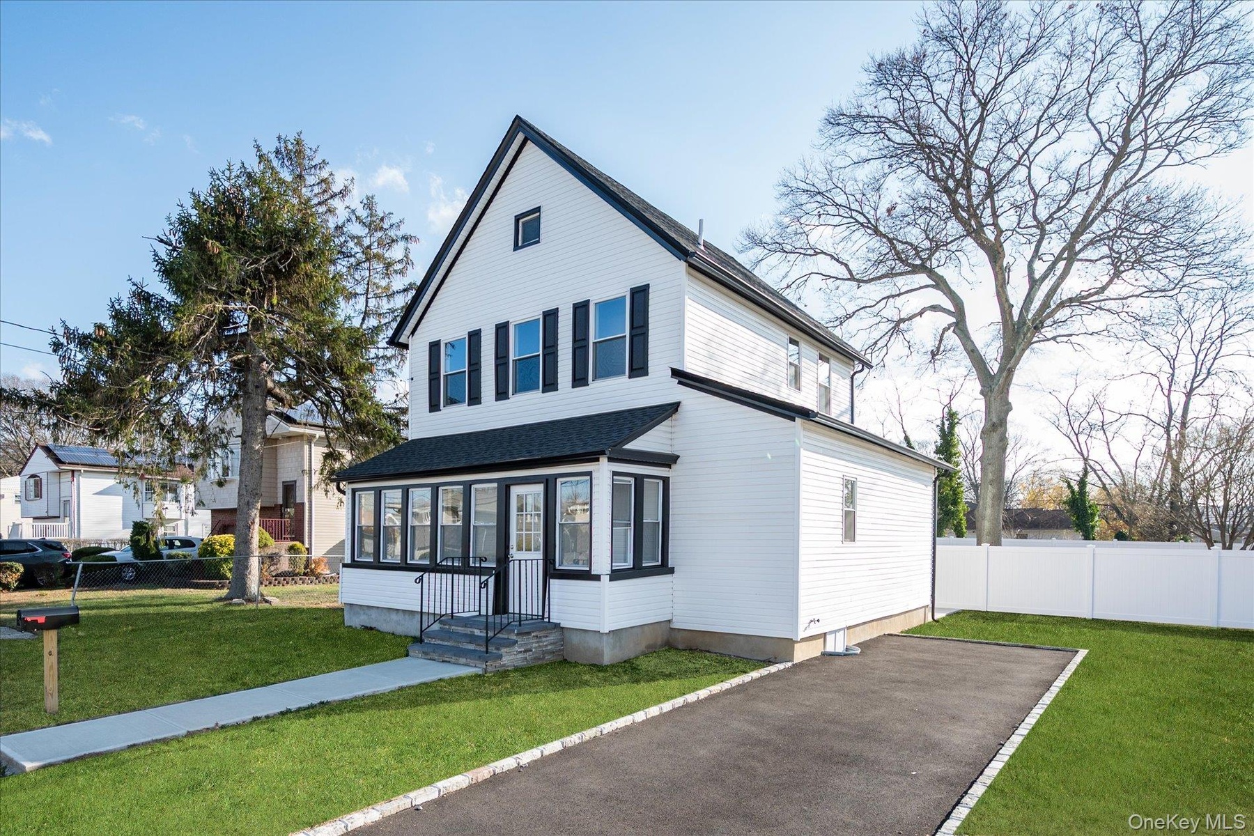View of front of house featuring a sunroom