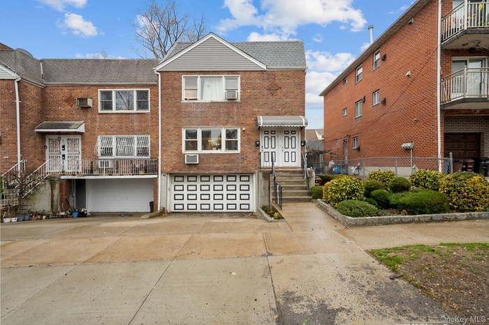 Traditional-style home with brick siding, an attached garage, and concrete driveway