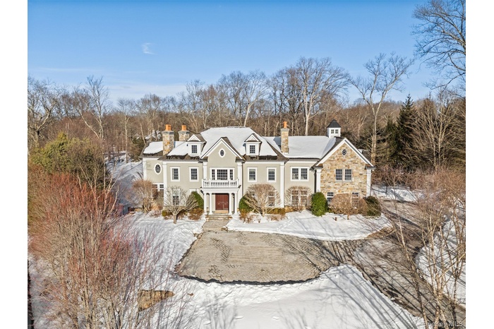 Desirable Gifford Lake Estate in Armonk  NY, set on 2.195 spectacular, level acres. Enjoy exceptional privacy in a serene setting, just minutes from d