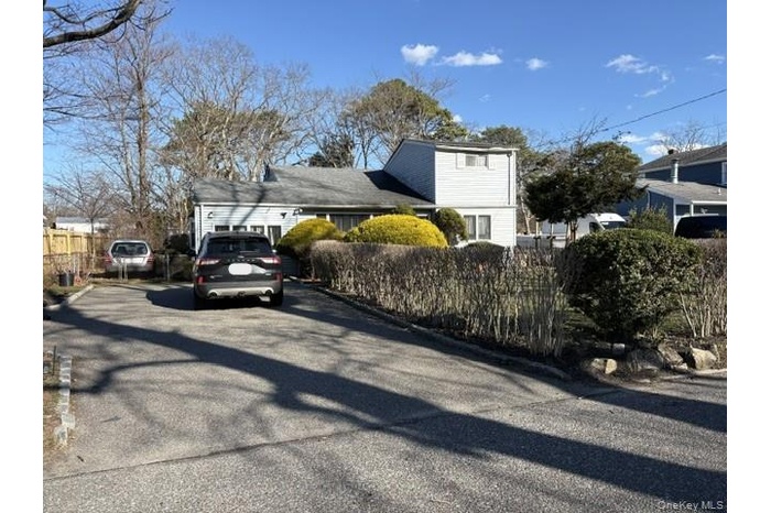 View of home's front exterior with asphalt driveway