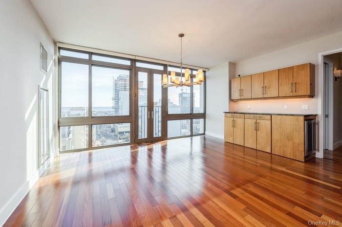 Spacious living room with custom built-ins, great water views.