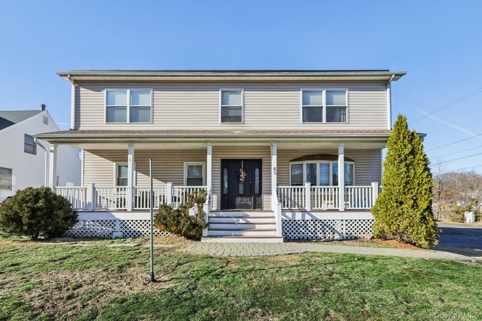 View of front of home with a front lawn and a porch