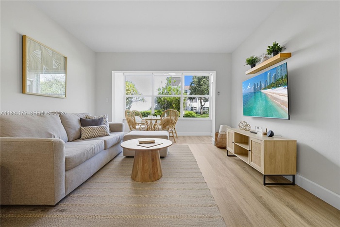 Open concept dining and living room area, connects to the enclosed patio.